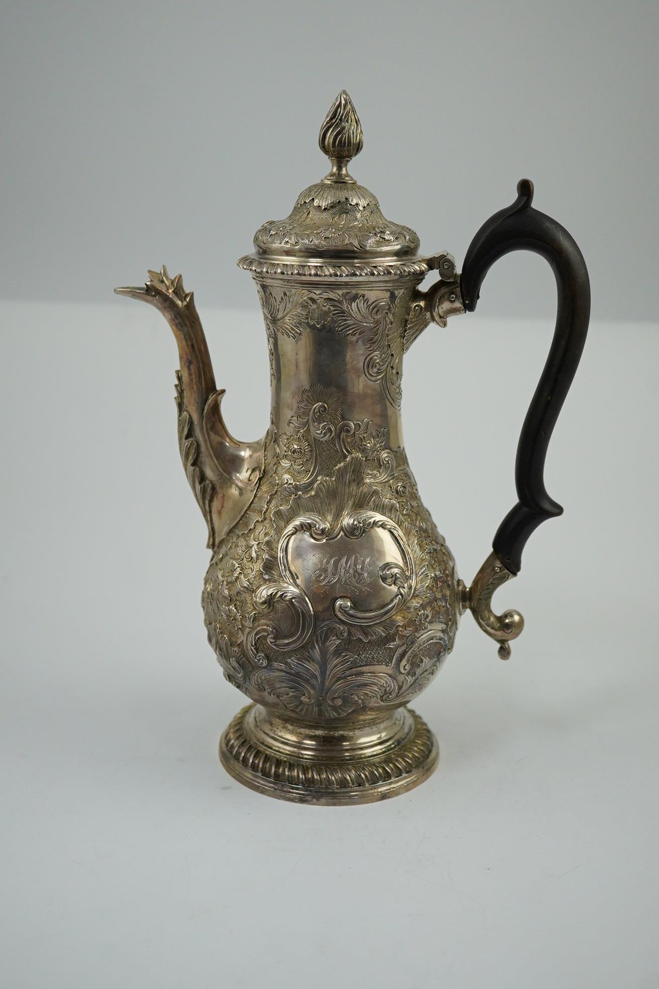 A George III silver coffee pot, by Aldridge & Green, with later embossed decoration